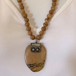 Vintage stone and silver tone pendant on wood vein jasper necklace